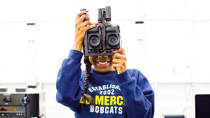female student using a video camcorder